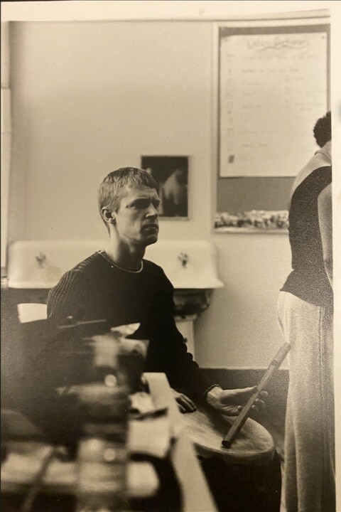 Michael Wall accompanying a dance class with a hand drum and wooden flute.
