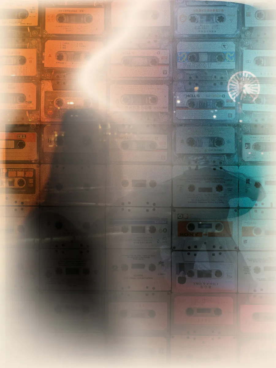 A collage of cassette tapes and projected light